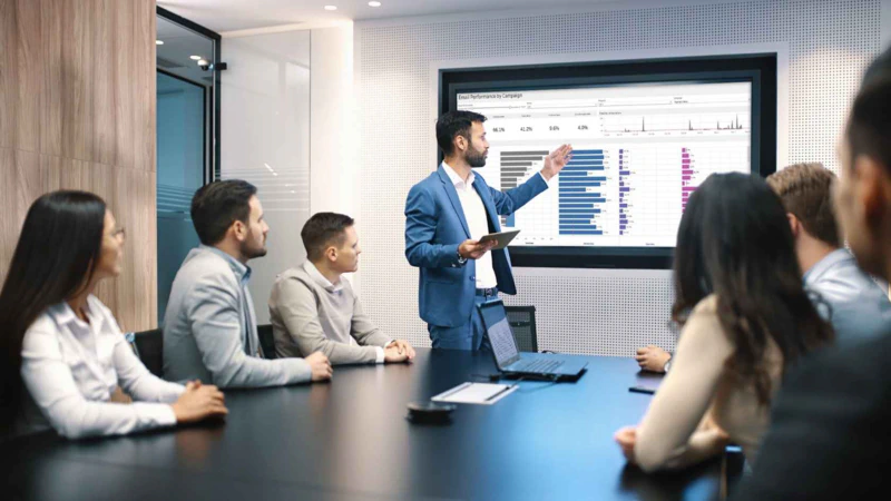 People at office with Tableau Dashboard