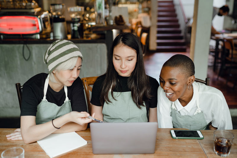 Waitress Watching Tutorial on Laptop